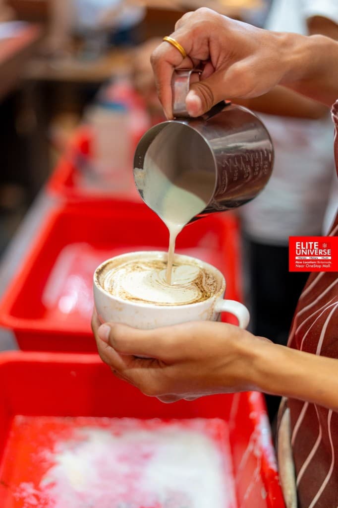 Latte art pour at Elite Universe barista training